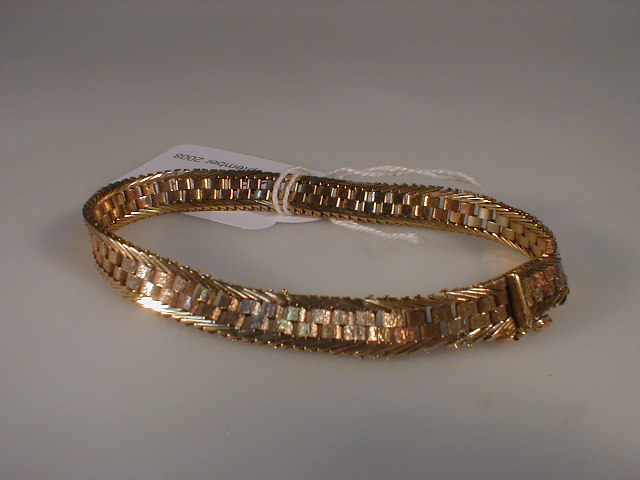 Appraisal: A tri-colour brick link and border pattern bracelet import marks