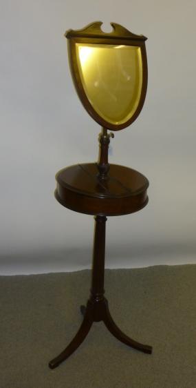 Appraisal: A VICTORIAN MAHOGANY SHAVING STAND the shield shaped plate on