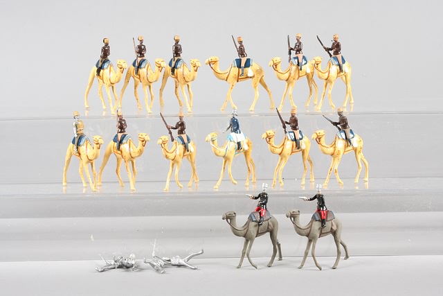 Appraisal: Lot of metal camels with riders representing Egyptian and French