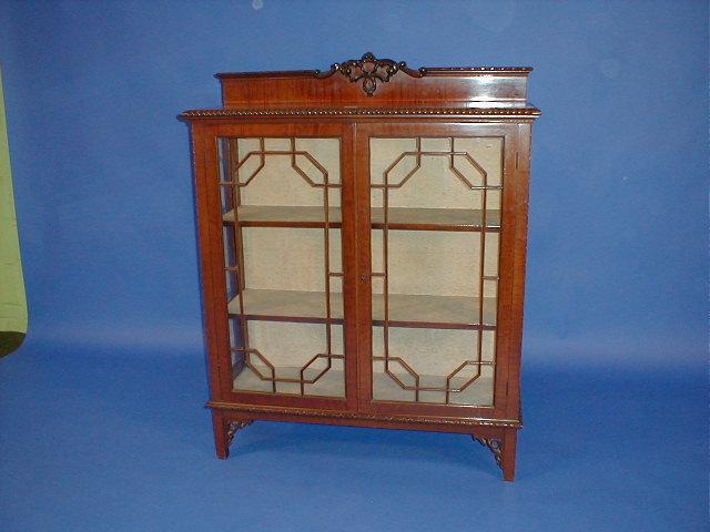 Appraisal: An Edwardian mahogany two door display cabinet in the Chinese