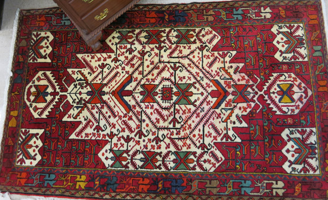 Appraisal: PERSIAN TRIBAL AREA RUG central geometric reserve and stylized floral