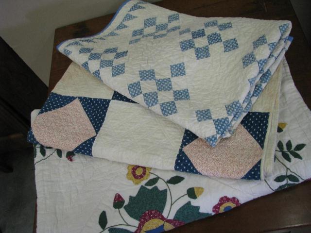 Appraisal: Three quilts including flower applique in red green and yellow