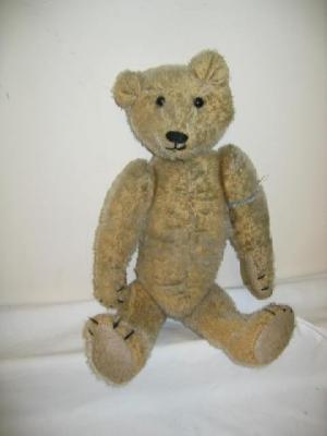 Appraisal: A tall gold plush articulated teddy bear with boot black