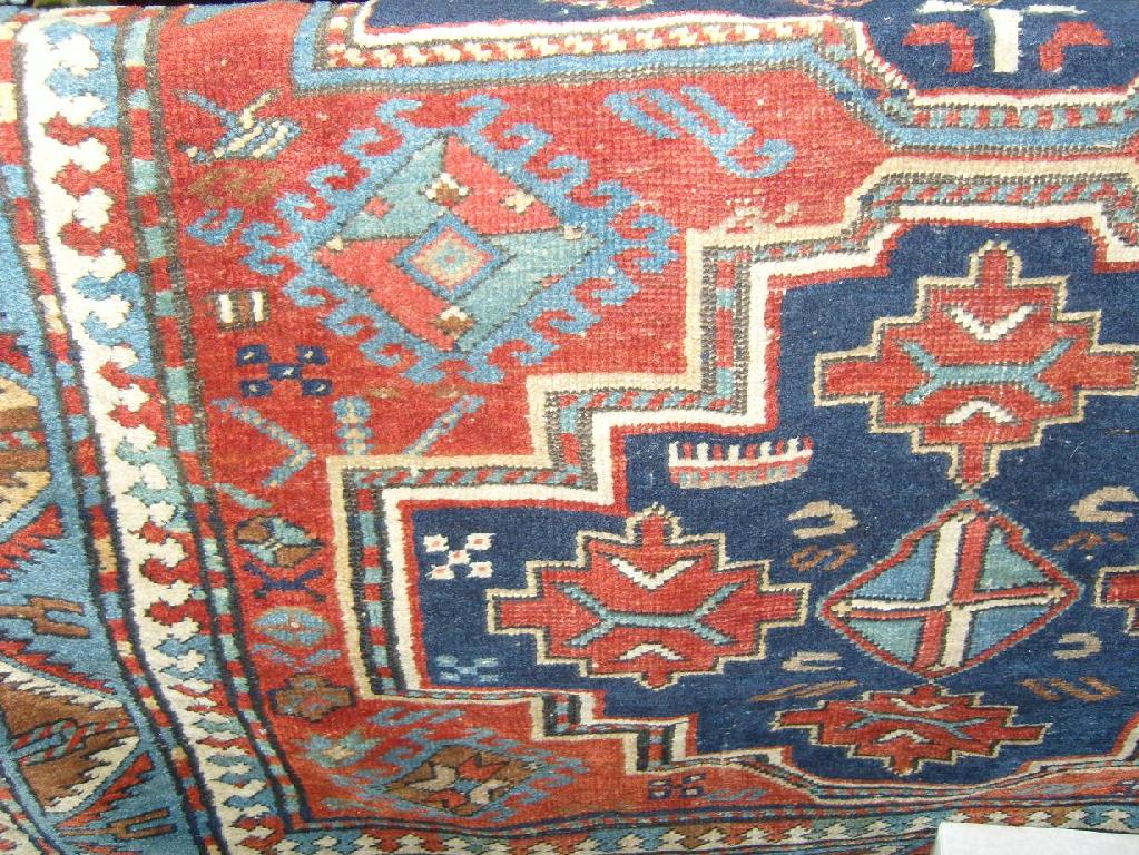 Appraisal: An eastern wool rug with geometric and hooked decoration in