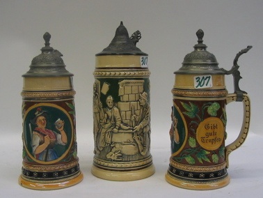 Appraisal: THREE GERMAN GLAZED POTTERY BEER STEINS all with pewter lids