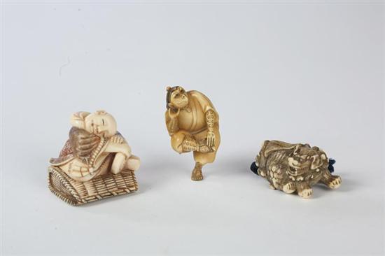 Appraisal: THREE NETSUKES Japanese th century ivory Foo lion l a