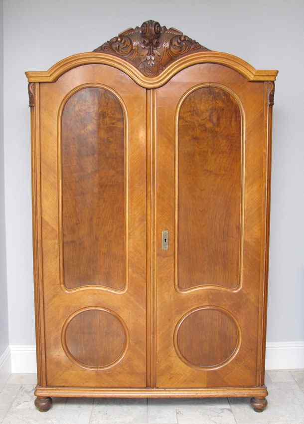 Appraisal: CARVED FRENCH ARMOIRE Carved crest shaped top paneled doors ''