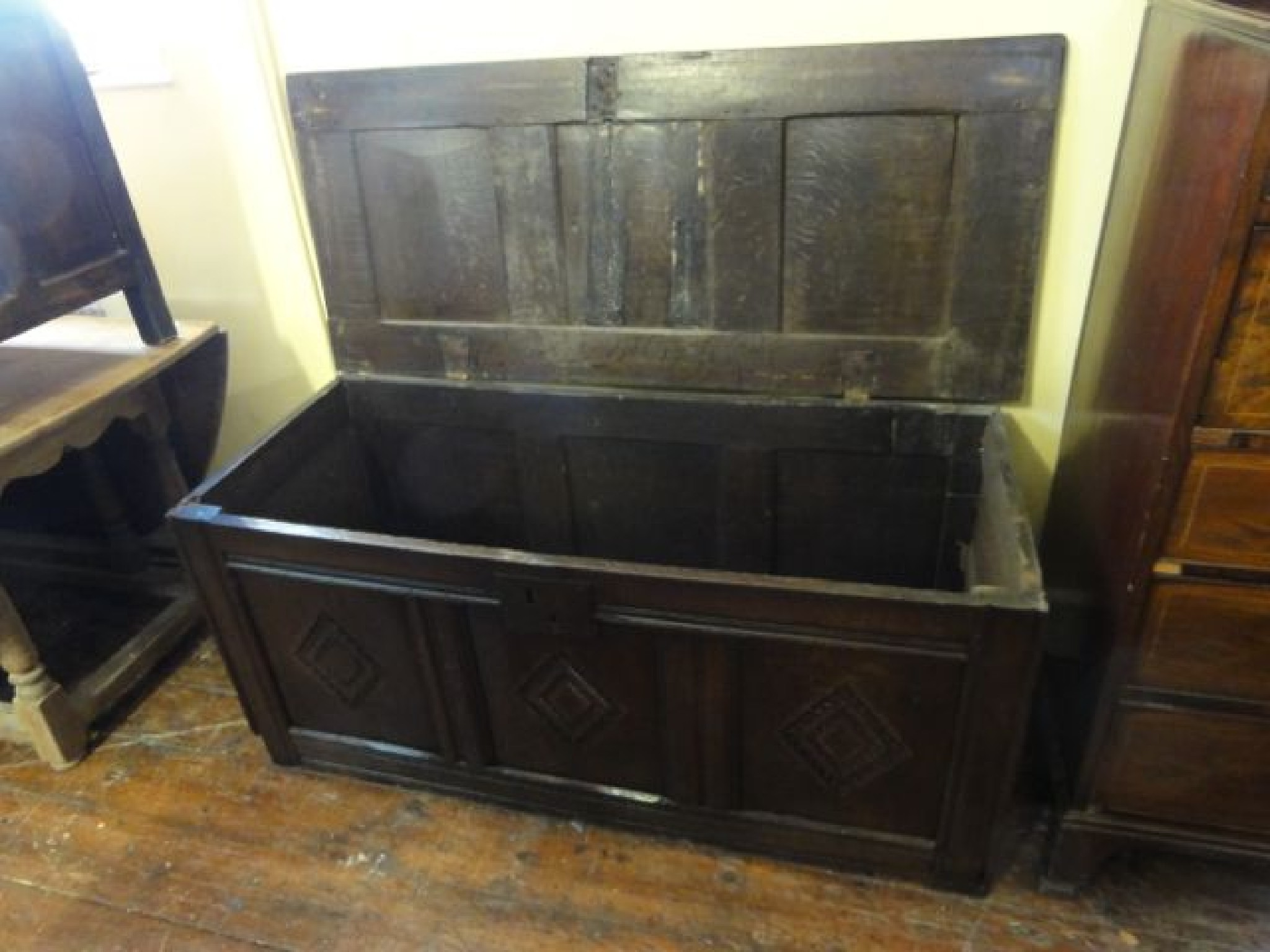 Appraisal: An th century oak coffer with panelled framework and lozenge