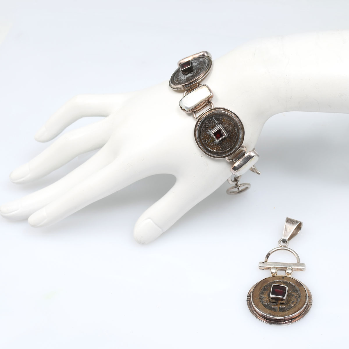 Appraisal: KOHNFELDER OBSIDIAN STERLING BRACELET AND PENDANT '' sterling discs are