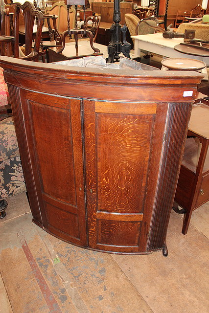 Appraisal: A TH CENTURY OAK BOW FRONTED HANGING CORNER CUPBOARD with