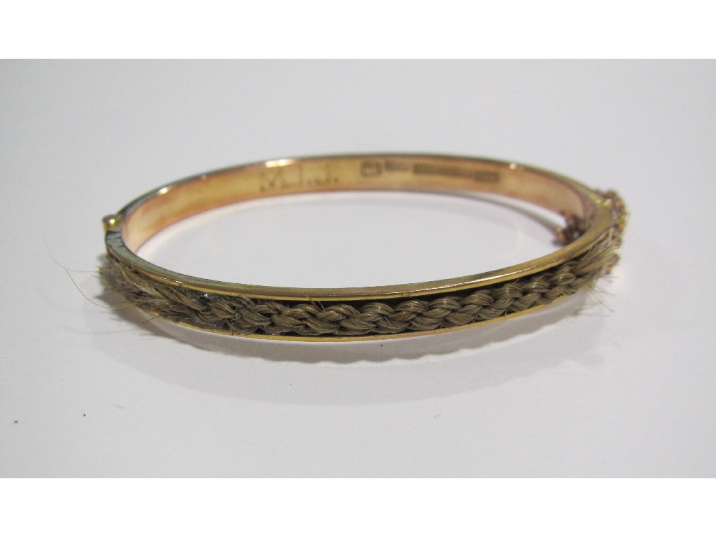 Appraisal: A Rhodesian gold remembrance bangle with woven hair inset