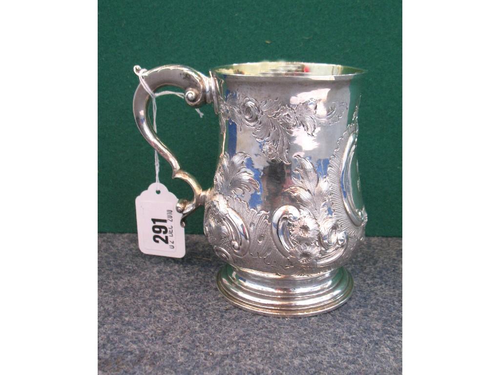 Appraisal: A GEORGE III SILVER MUG with repouss foliate decoration