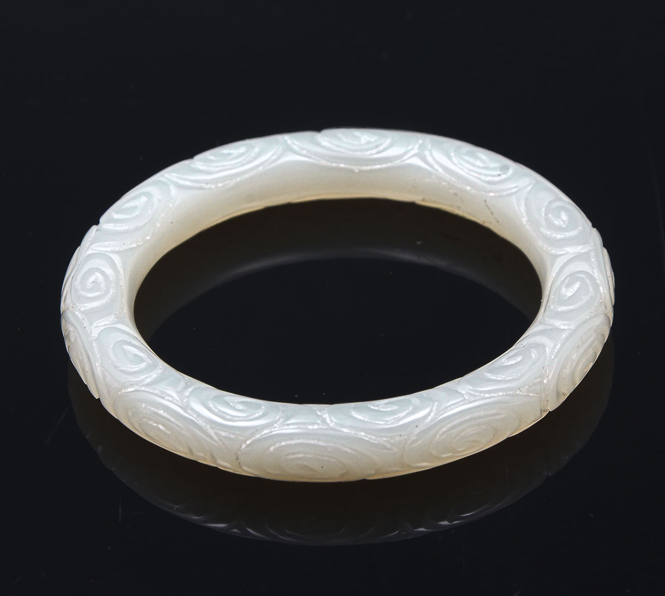 Appraisal: CARVED WHITE JADE BRACELET Chinese white jade bracelet having an