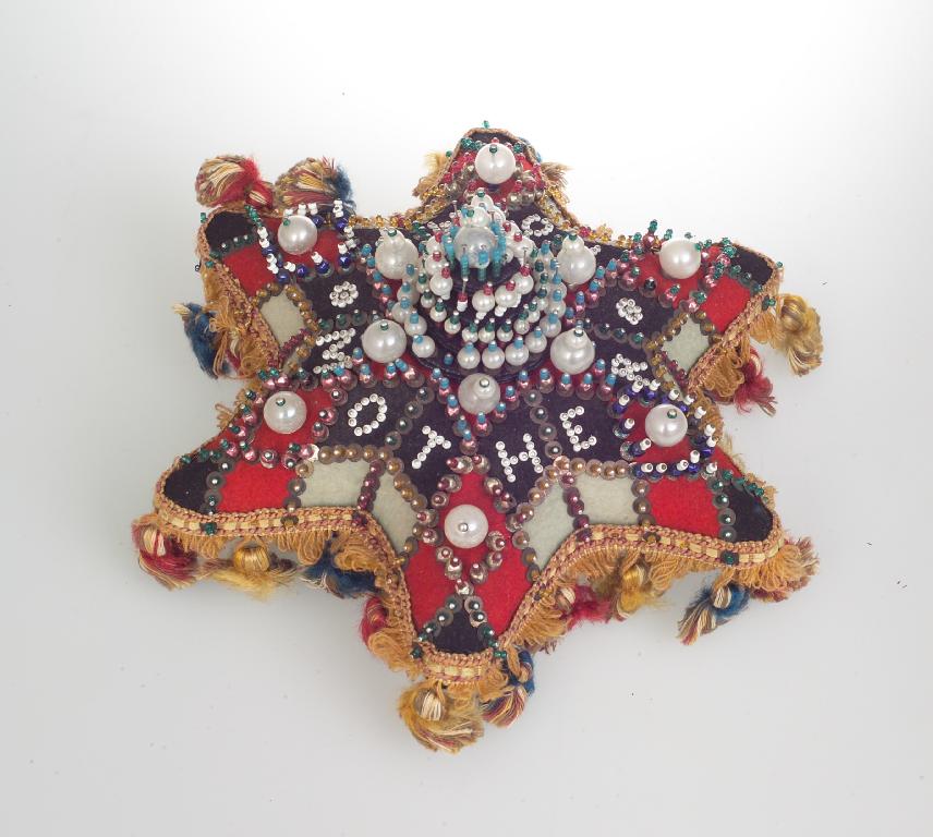 Appraisal: VICTORIAN SWEETHEART PINCUSHION of star-form geometrically decorated with stick pins