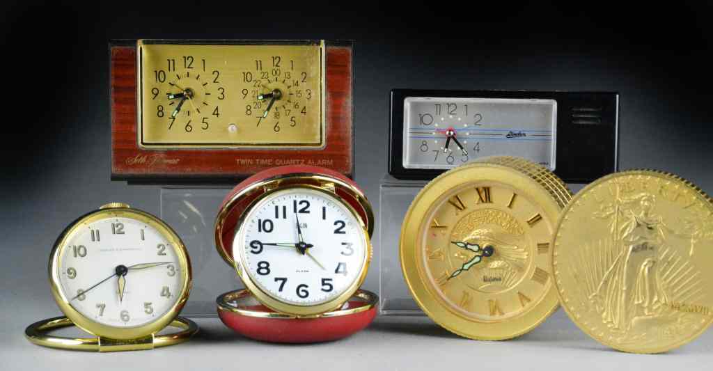 Appraisal: Alarm ClocksTo include a Bulova clock resembling a large twenty-dollar