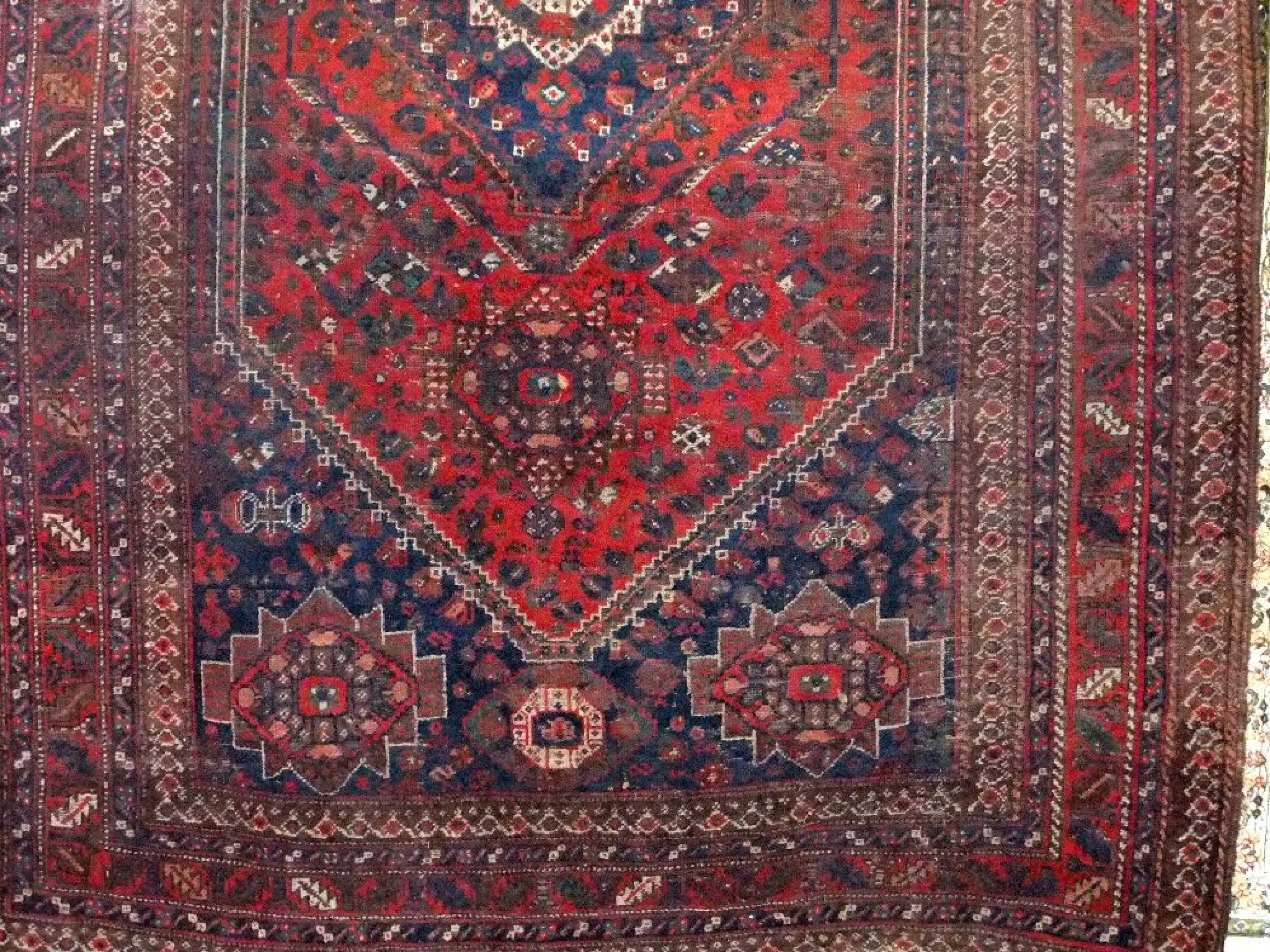 Appraisal: A Persian wool carpet with red ground field central blue