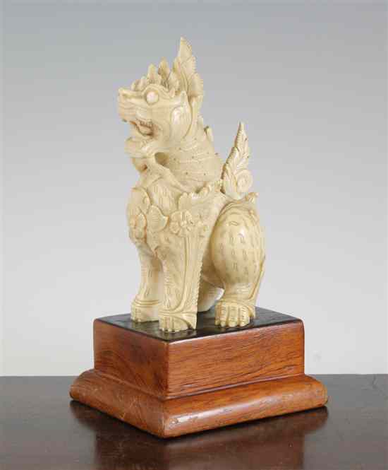 Appraisal: A Burmese ivory figure of a seated Buddhist lion first