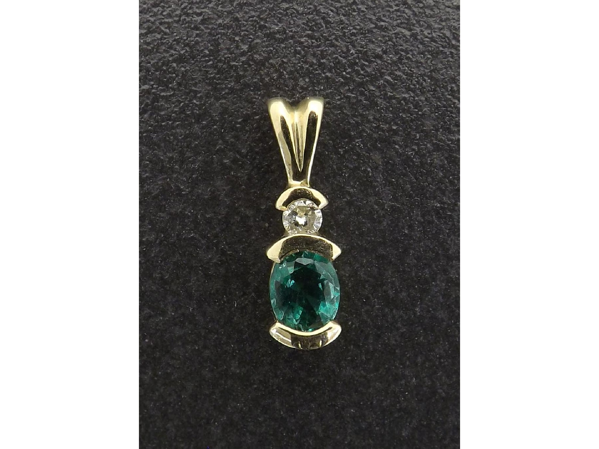 Appraisal: k emerald and diamond pendant mm