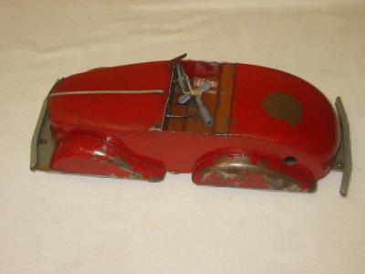 Appraisal: A pre-war tin plate open sports car clockwork motor with