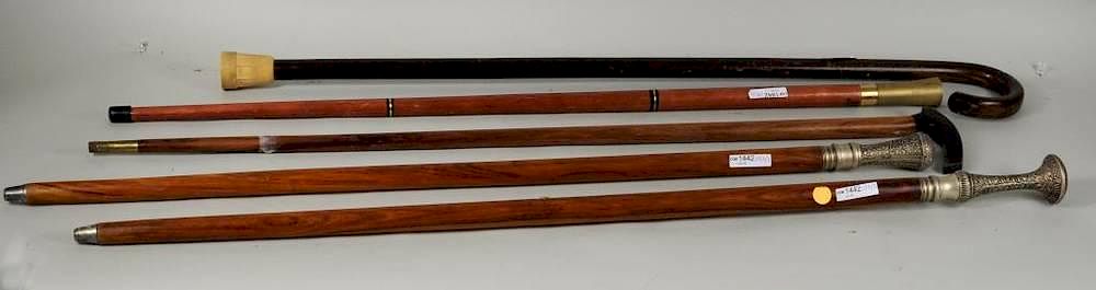 Appraisal: Five Brass Wood Canes Five brass and wood canes long