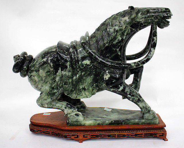 Appraisal: A LARGE CARVED JADEITE OR HARDSTONE SCULPTURE OF A HORSE