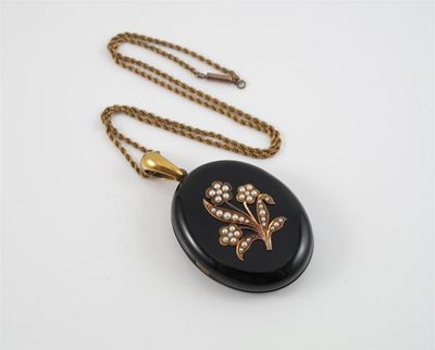 Appraisal: A Victorian black onyx mourning locket pendant Set with a