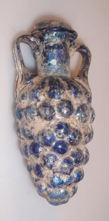 Appraisal: A heavily restored iridescent blue glass amphoriskos the everted mouth