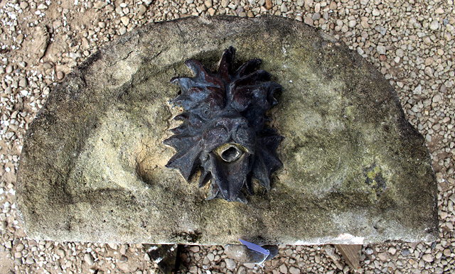 Appraisal: A CARVED STONE AND CAST LEAD MOUNTED FOUNTAIN HEAD in