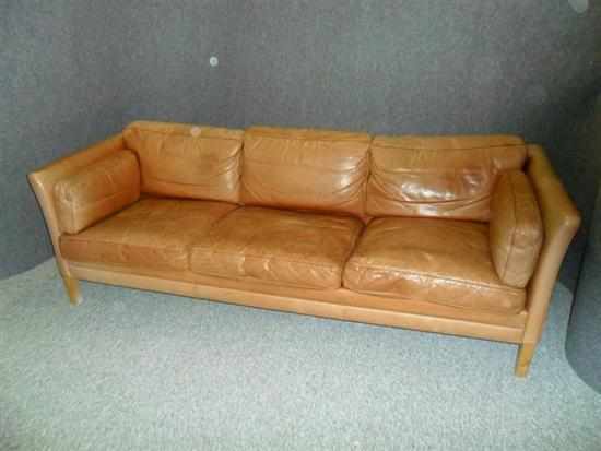 Appraisal: A DANISH TAN LEATHER THREE SEAT SOFA raised on beech