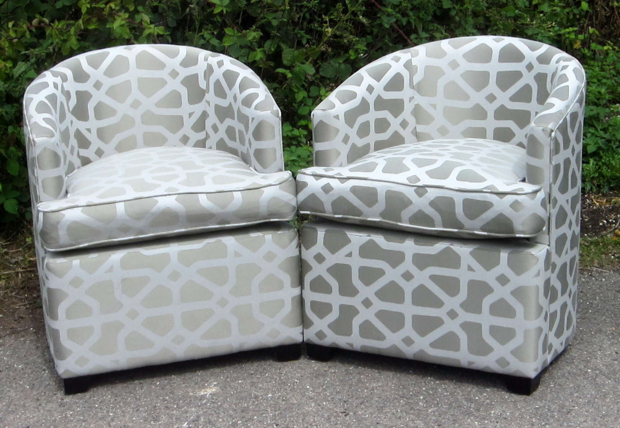 Appraisal: Pair of silver upholstered tub chairs with stylised design