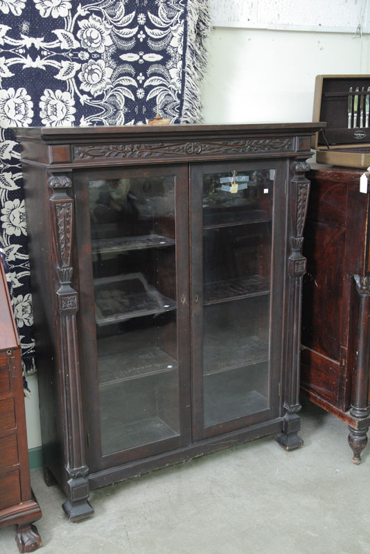 Appraisal: BOOKCASE Mahogany with a molded and carved cornice over two