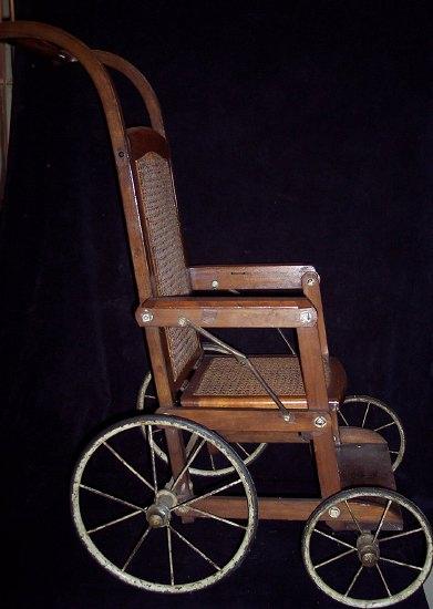 Appraisal: A child's Edwardian beech framed push chair the cane back