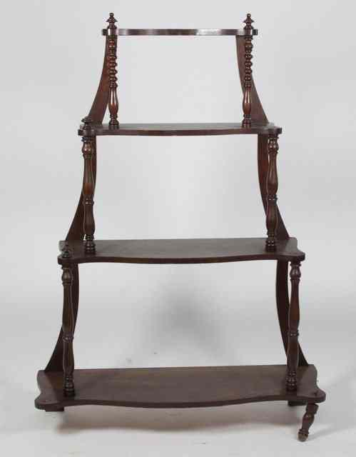 Appraisal: A Victorian walnut serpentine front four-tier whatnot the graduated tiers