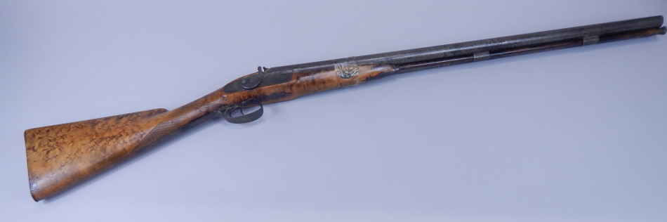 Appraisal: A muzzle loading double barrel shotgun indistinctly engraved with the