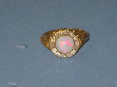 Appraisal: A VICTORIAN OPAL AND DIAMOND RING the central round cabochon