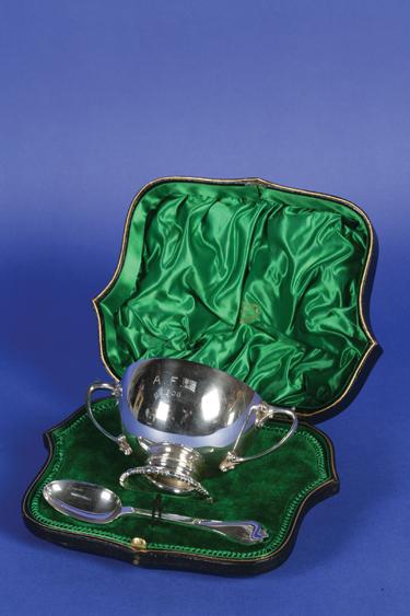 Appraisal: AN EDWARDIAN CHRISTENING BOWL AND SPOON the bowl with scroll