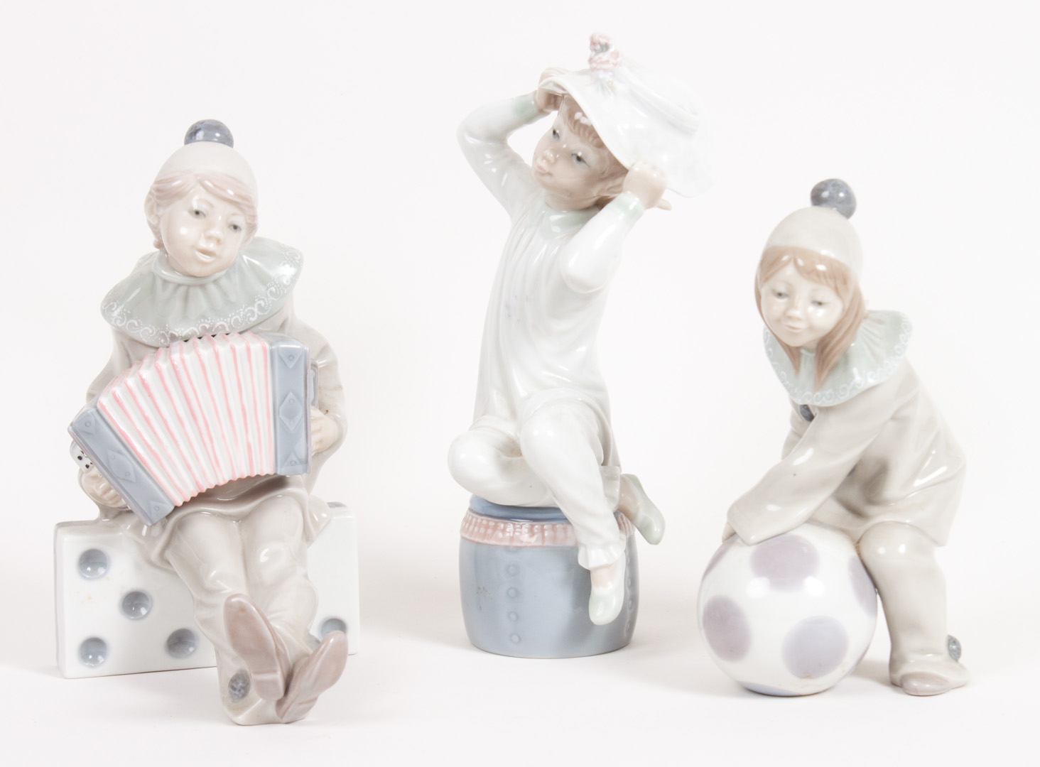 Appraisal: Three Lladro porcelain figures including girl clown with ball seated