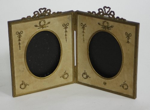 Appraisal: An ormolu mounted folding panel photograph frame topped with ribbon