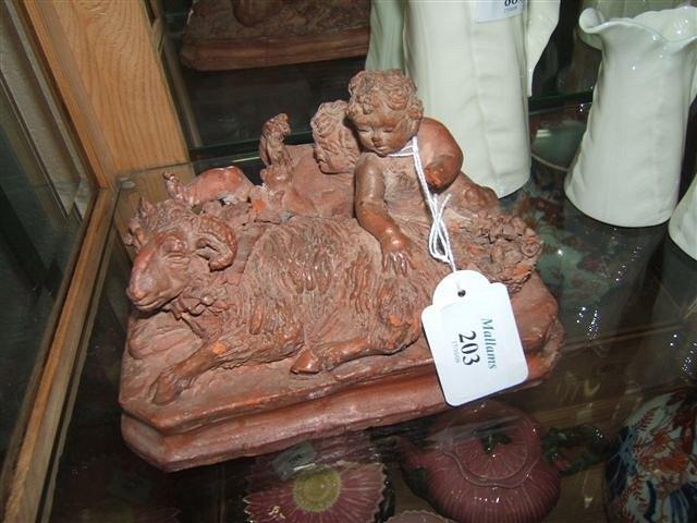 Appraisal: A terracotta sculpture of two Bacchanalian putti resting beside a