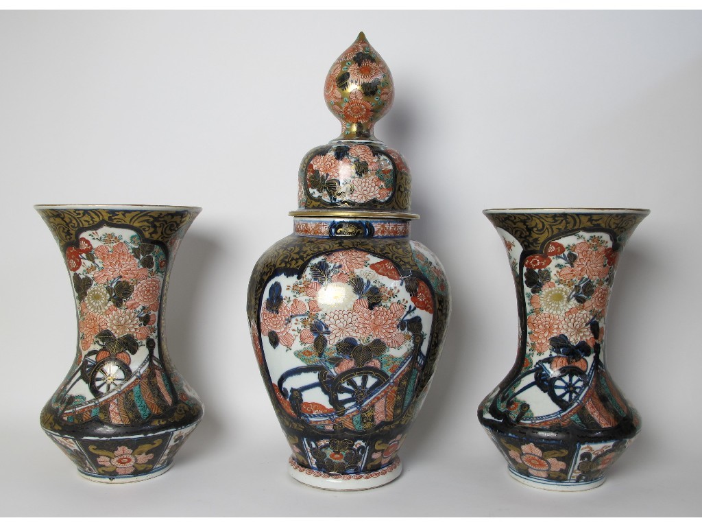 Appraisal: An Imari garniture comprising a baluster vase and cover and