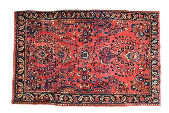 Appraisal: ORIENTAL RUG Sarouk Blue border and red ground ' x