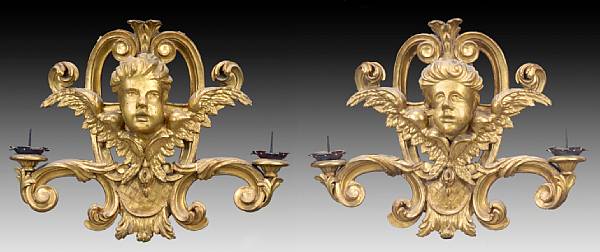 Appraisal: A pair of Italian Baroque carved giltwood two-light sconces Each