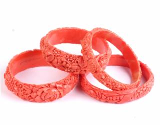 Appraisal: Four 's Celluloid Faux Coral Bangles Four 's celluloid faux