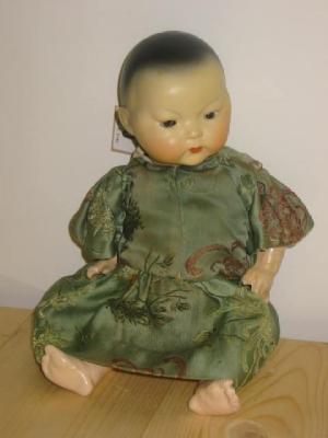 Appraisal: A German bisque Oriental doll with brown sleeping eyes painted