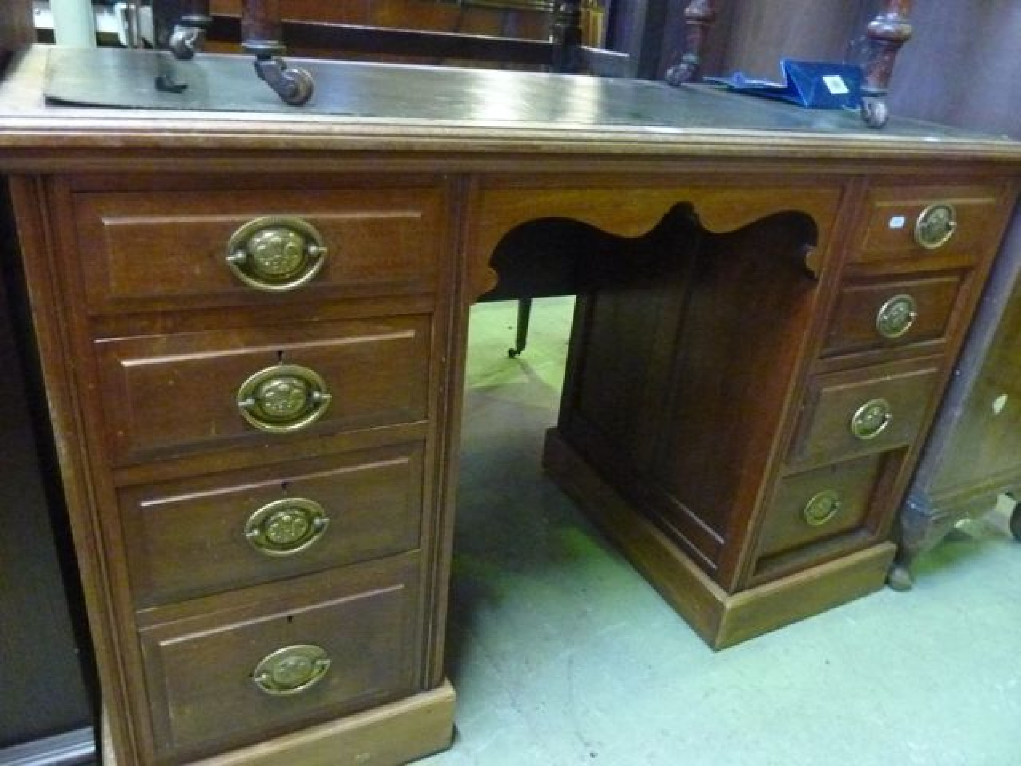 Appraisal: An Edwardian walnut kneehole twin pedestal writing desk of rectangular