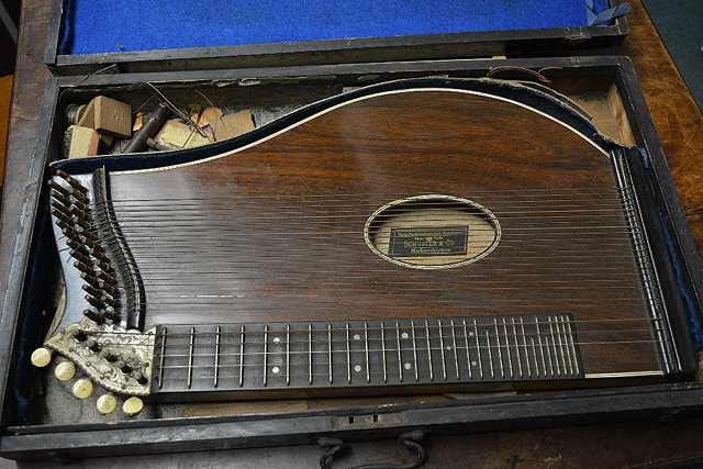 Appraisal: A zither by Schuster Coin an ebonised case