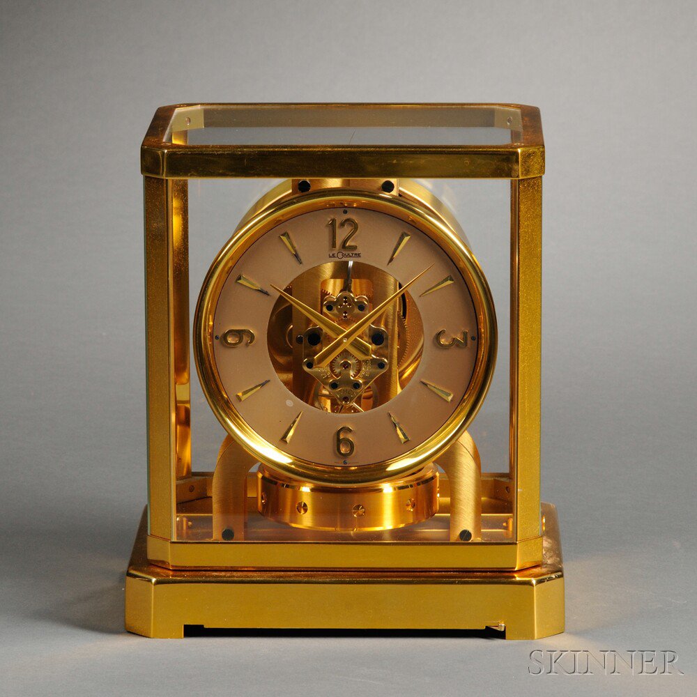 Appraisal: Atmos Brass and Glass Clock by Le Coultre Switzerland pink-tone