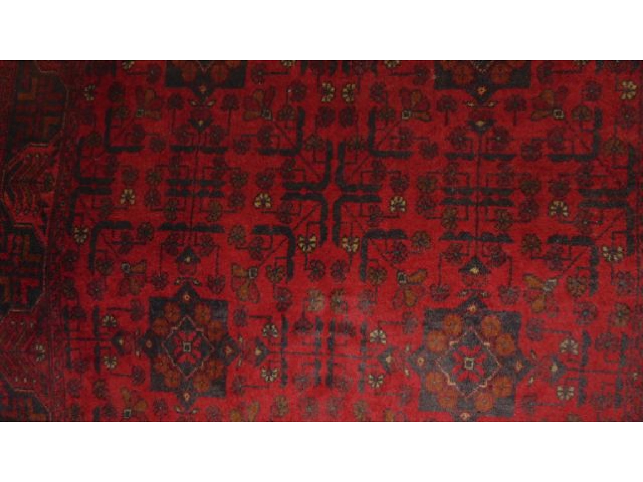 Appraisal: A Persian wool rug in a red colourway with geometric