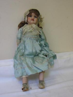 Appraisal: An English bisque shoulder head girl doll with fixed blue