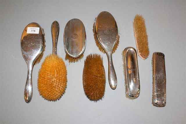 Appraisal: A COLLECTION OF EIGHT VARYING SILVER BACKED BRUSHES